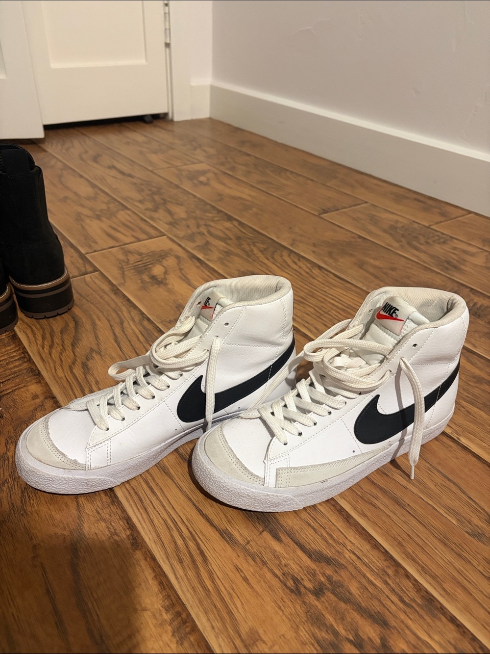 Nike High-Top Sneakers in White with Black Swoosh